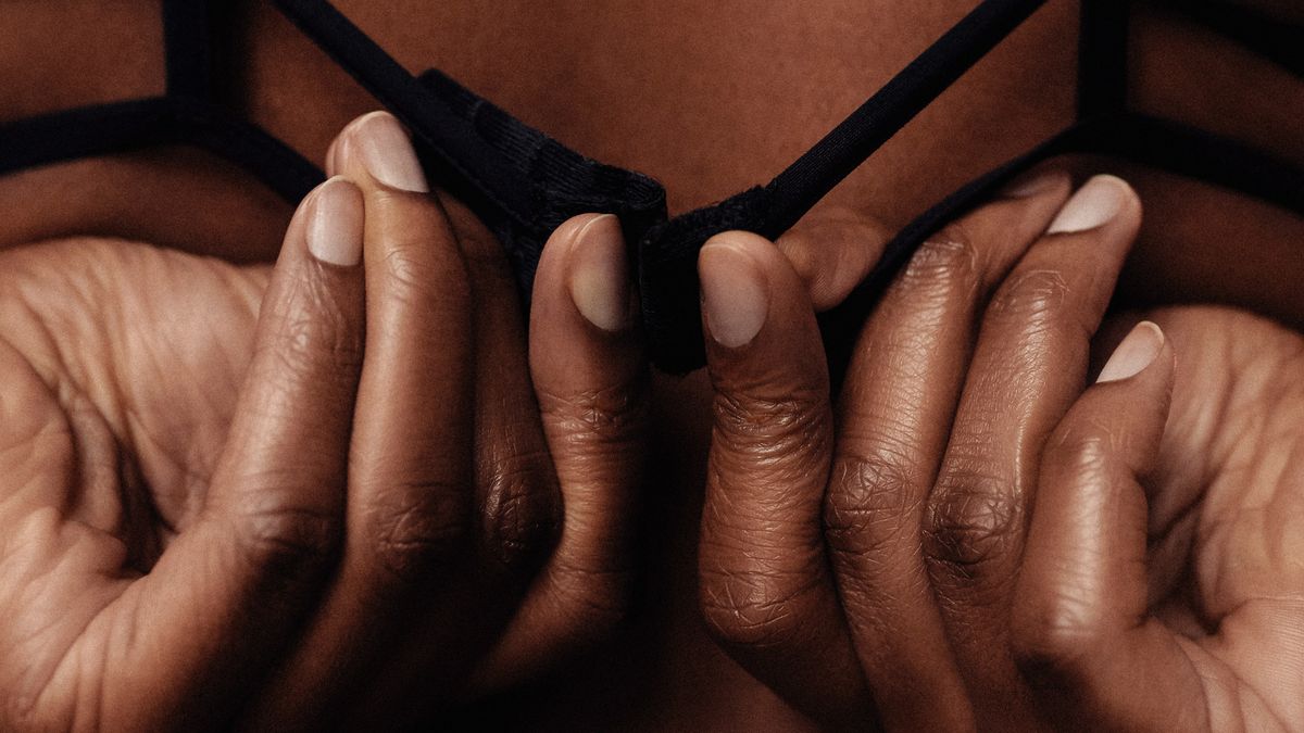 Une femme Antillaise dégraffe son soutien-gorge